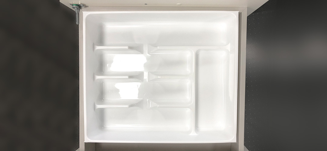 The Trend Double-Up Cutlery Tray in an office desk drawer